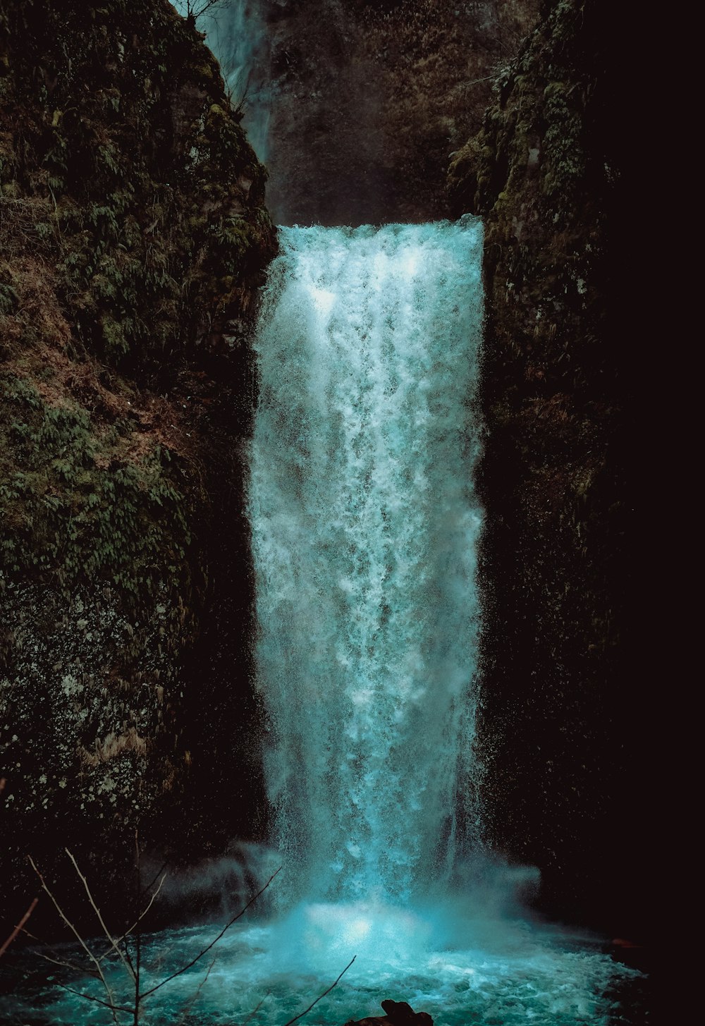 water falls on black and brown rocky ground