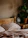 A cozy bedroom setup featuring wooden furniture with warm lighting.