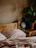 A cozy bedroom setup featuring wooden furniture with warm lighting.