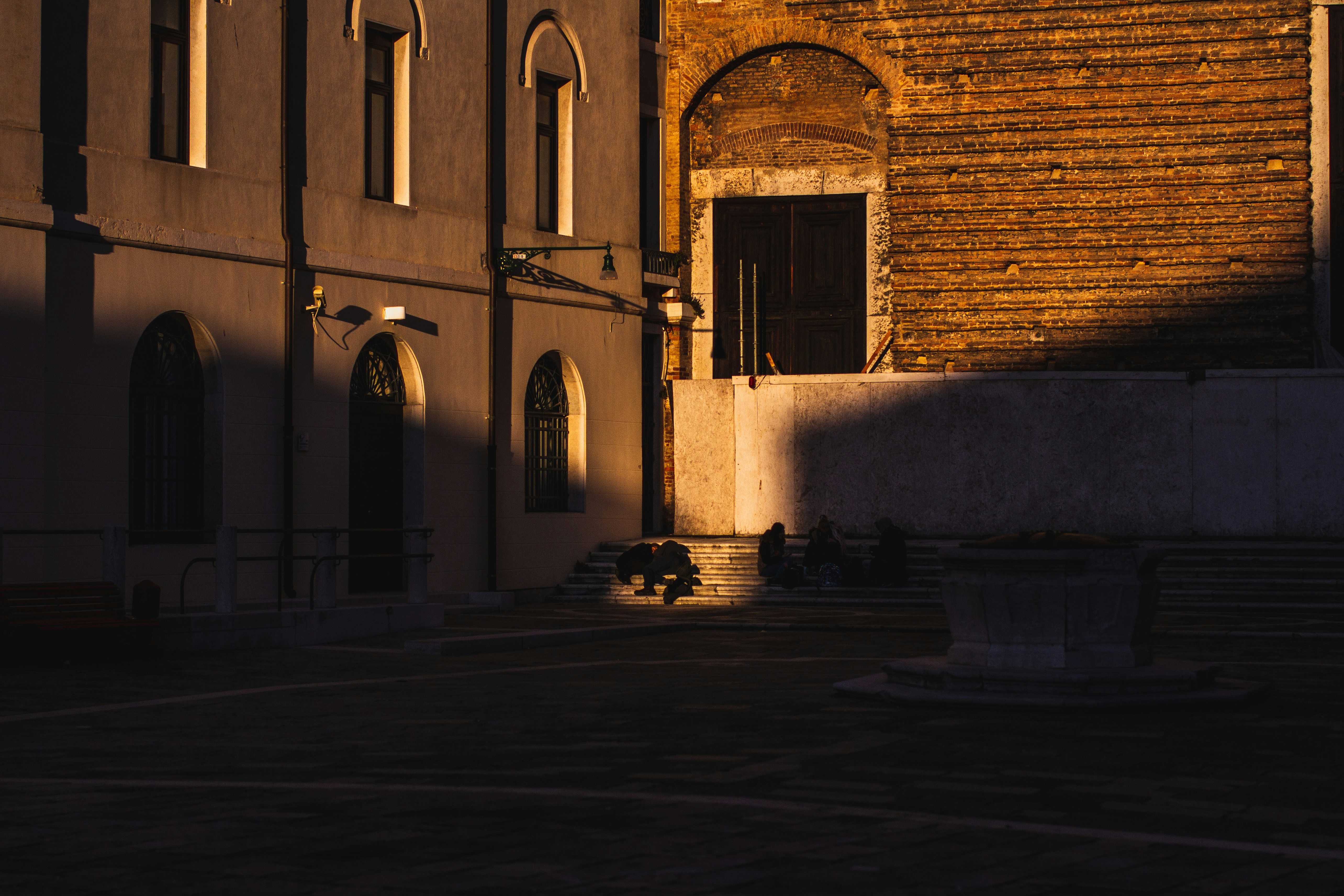 brown brick building with light turned on during daytime