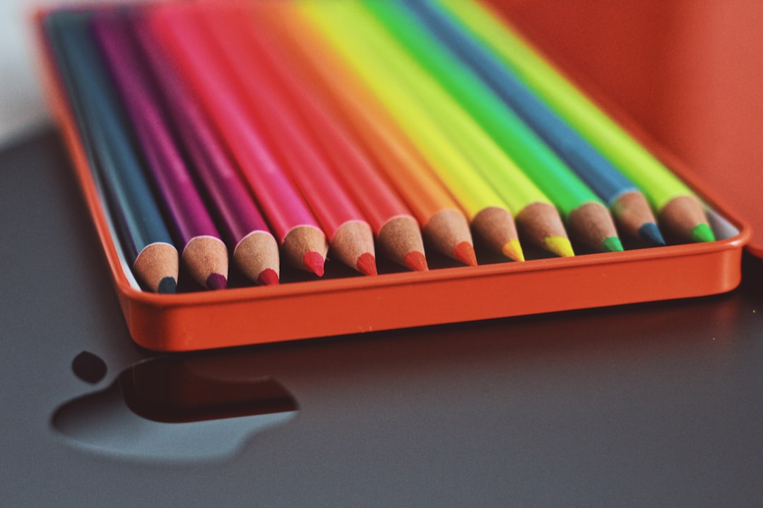 coloring pencils in red plastic container