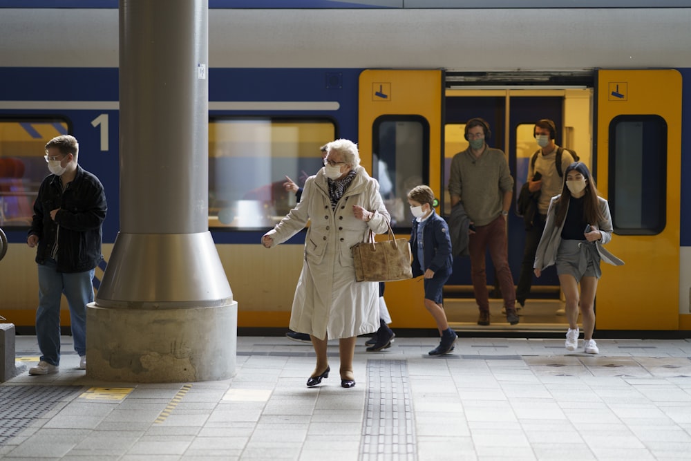 woman in white coat standing on white floor tiles