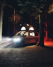 A cozy camper van with smart lighting and gadgets set up in a forest.