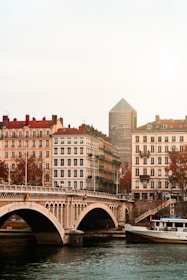 brown concrete building near bridge during daytime