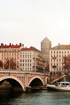 brown concrete building near bridge during daytime