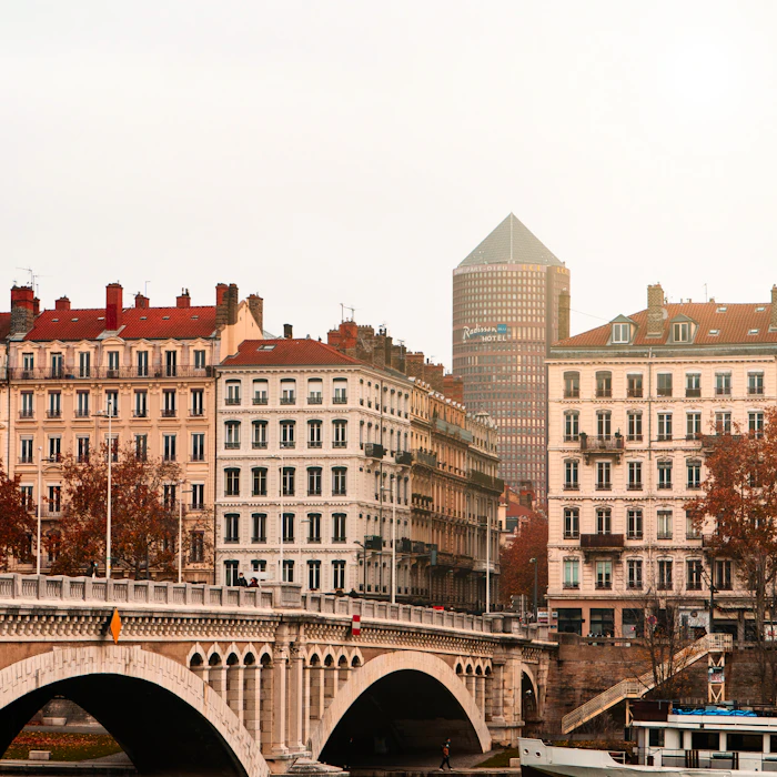 brown concrete building near bridge during daytime