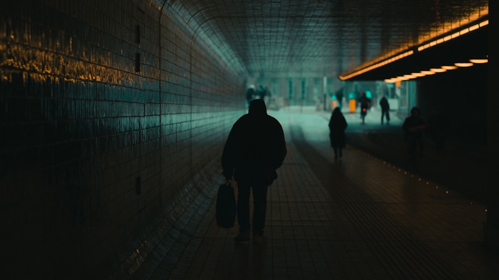 silhouette of man walking on hallway