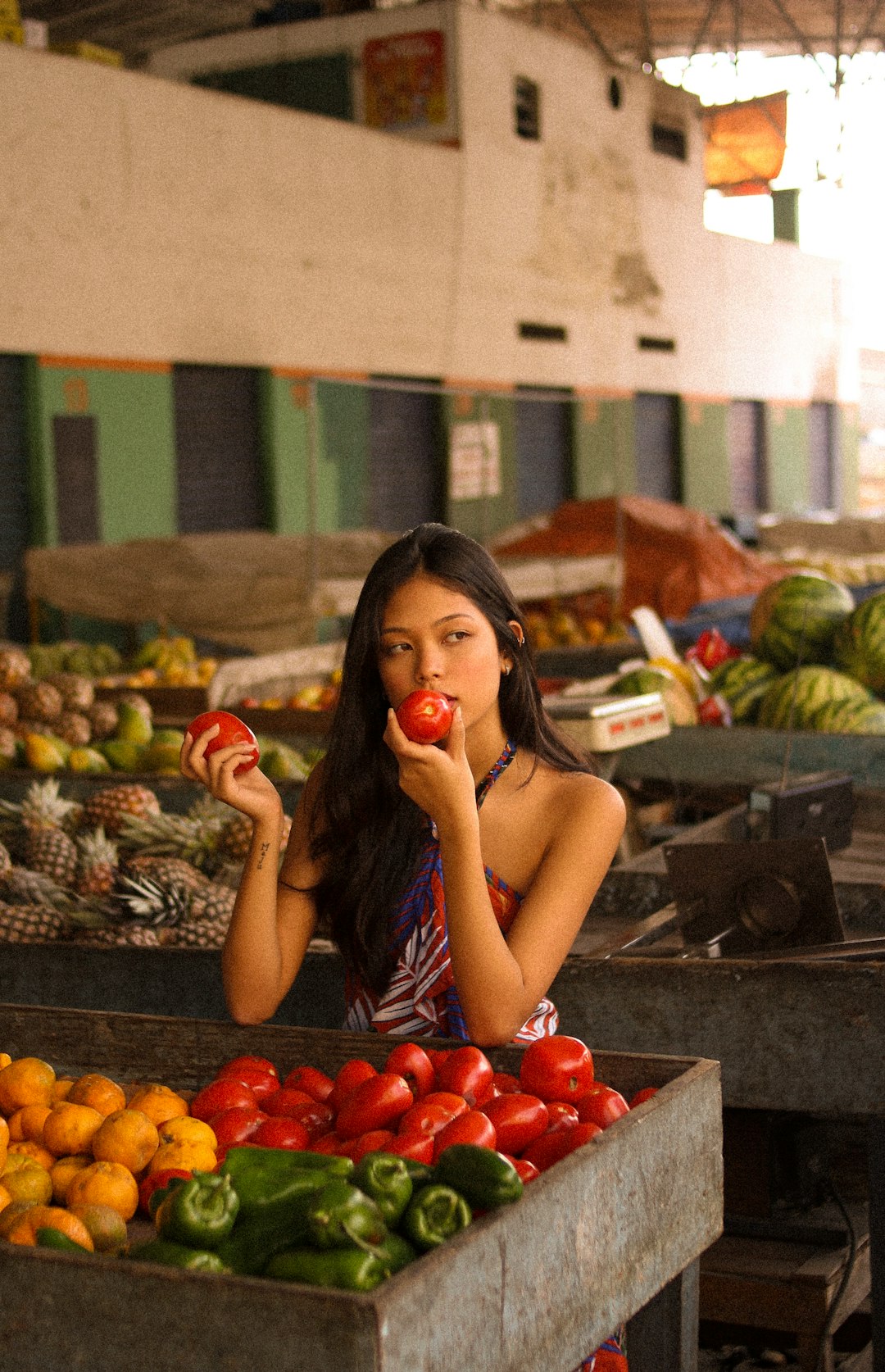 woman in yellow tank top holding apple fruit