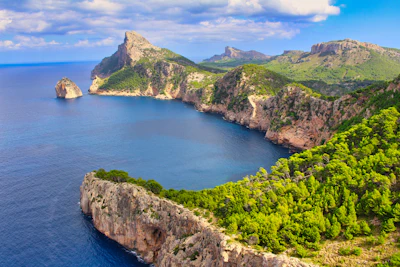 The pine-covered ridges of the Serra de Tramuntana dropping into the sea at Cap de Formentor, Mallorca