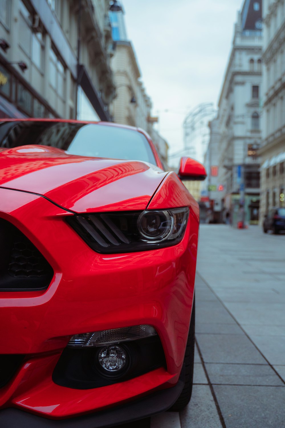 red bmw m 3 parked on sidewalk during daytime