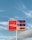 A gas station price sign stands against a backdrop of a blue sky with light clouds. The sign displays prices for regular cash, regular credit, and diesel, with the brand name Energy Fuels prominently featured on a red background.