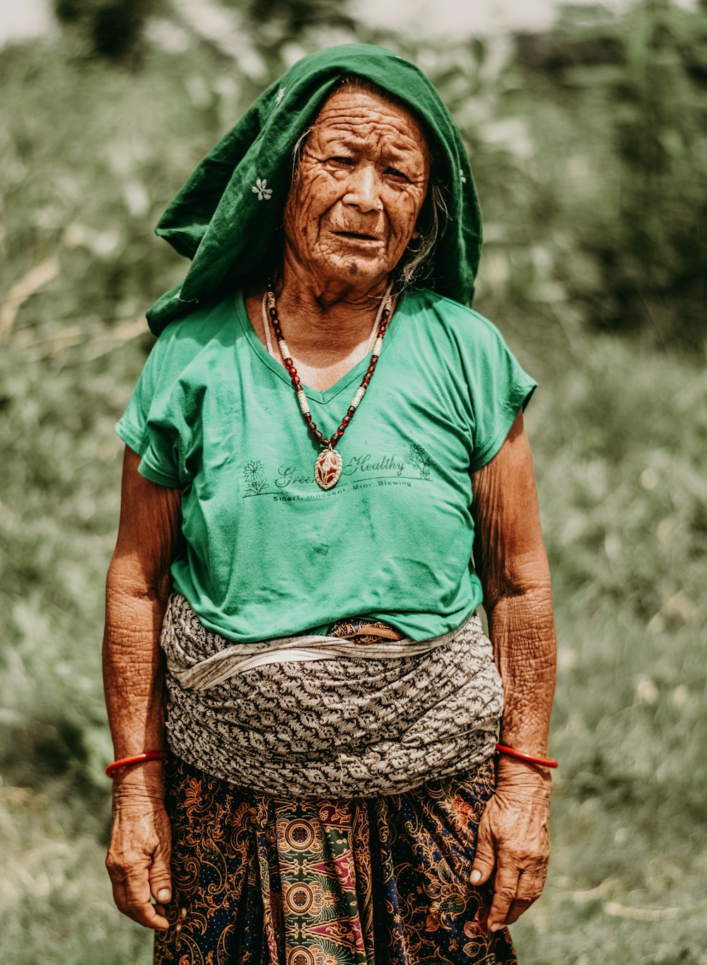 woman in green and brown dress wearing green scarf