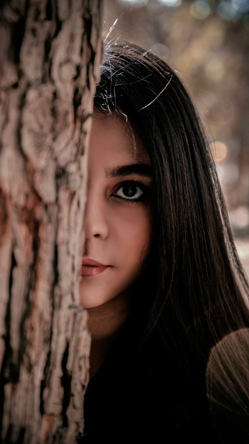 womans face on brown tree