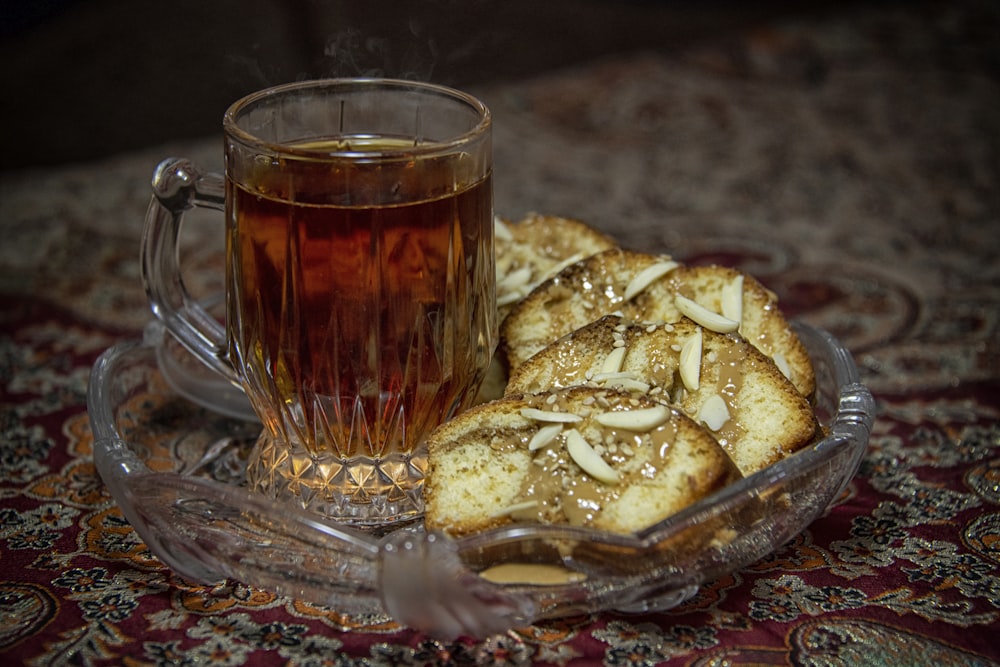 clear glass mug with brown liquid