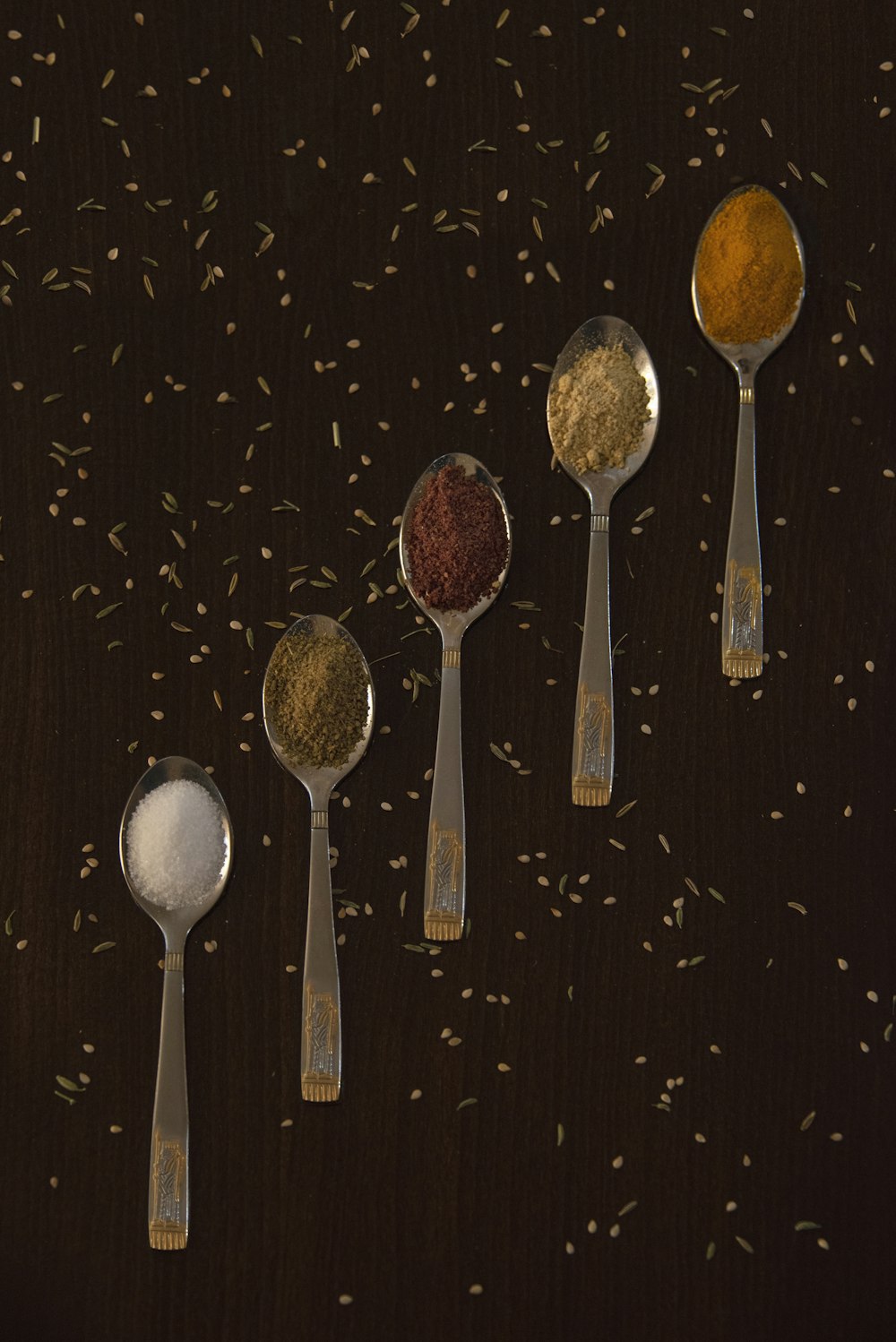 stainless steel spoons on black surface