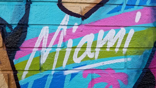 blue and pink painted wall that says Miami
