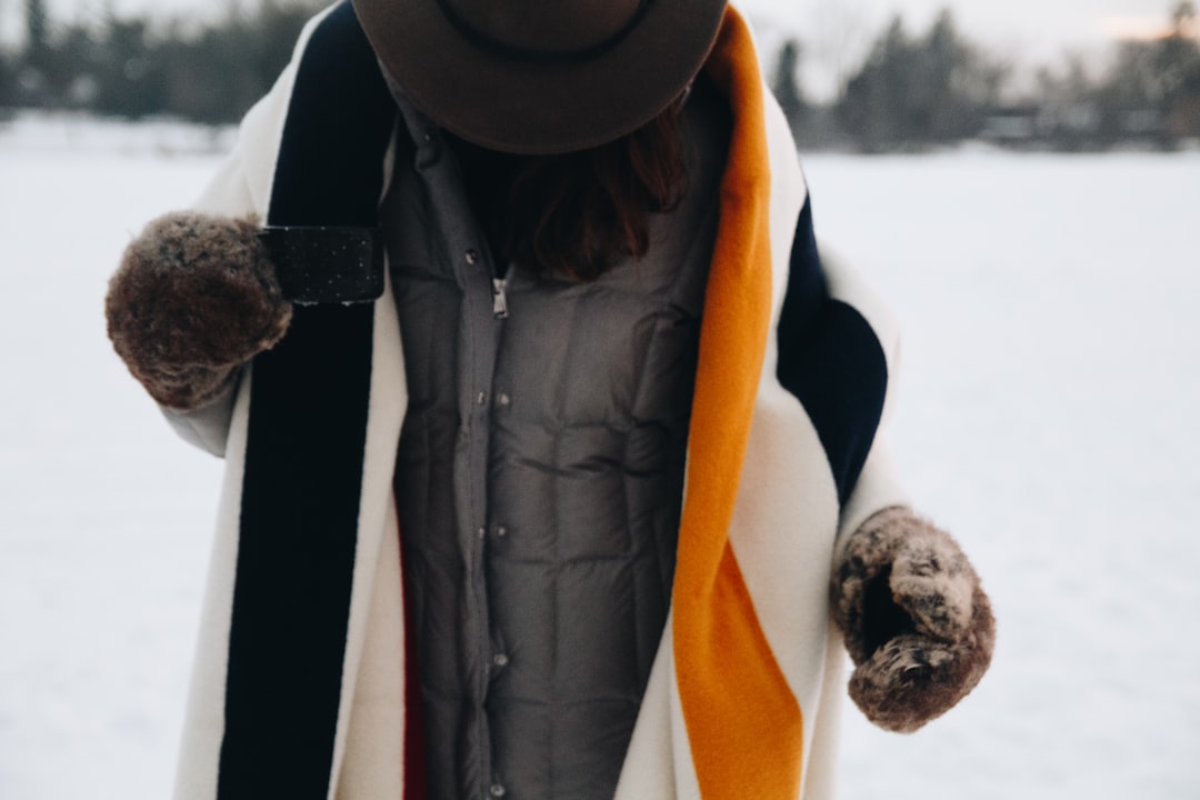 person in black and white jacket and black knit cap