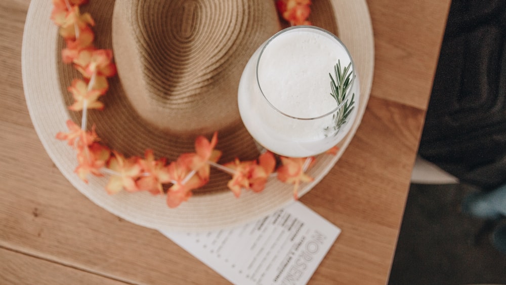 white fedora hat on brown wooden table