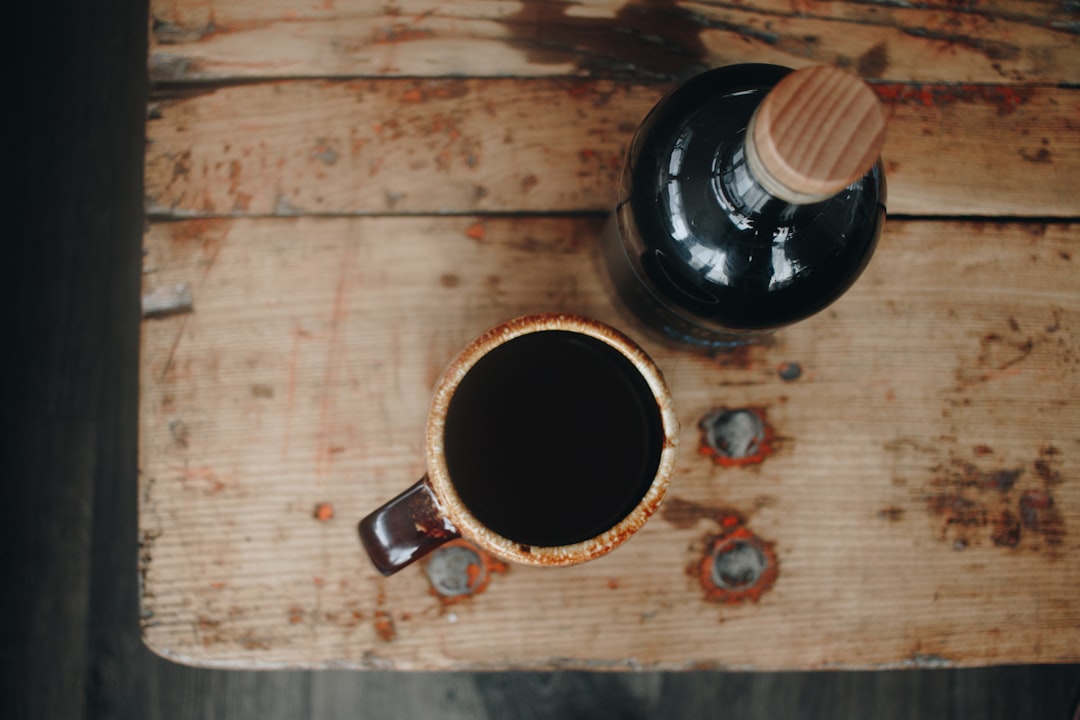 black ceramic mug on brown wooden table