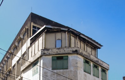 A rundown property with visible code violation notices on the door.