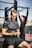 man in black nike crew neck t-shirt and black pants sitting on bench