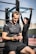 man in black nike crew neck t-shirt and black pants sitting on bench