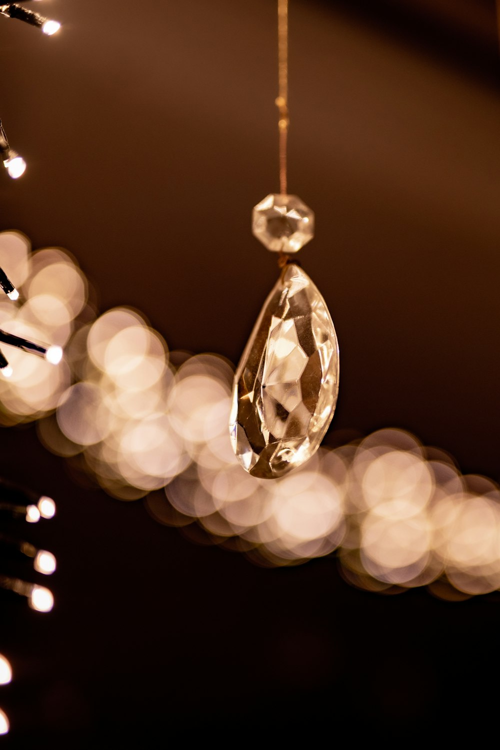 selective focus photography of clear glass pendant lamp