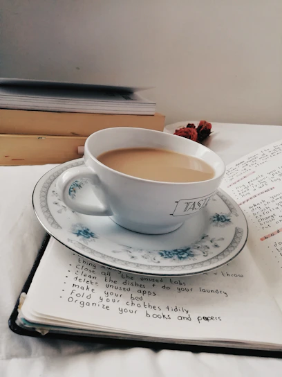 A serene morning scene with a cup of herbal tea and an open notebook filled with brain-boosting tips.