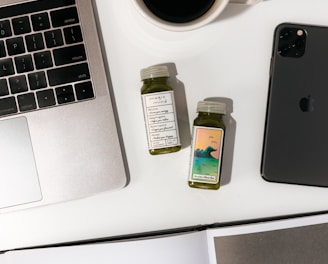 black iphone 7 beside white ceramic mug on white table