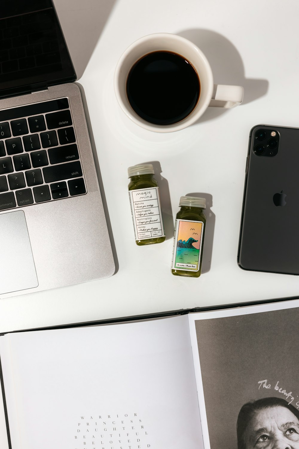 black iphone 7 beside white ceramic mug on white table