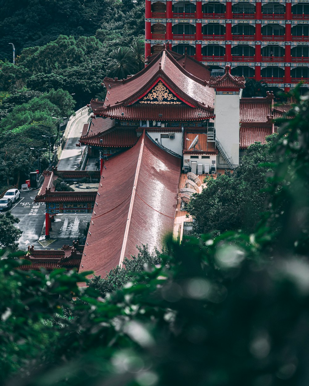 brown and white house surrounded by green trees