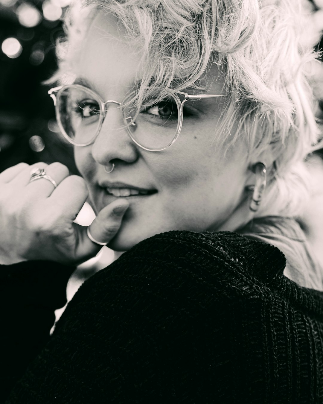 woman in black sweater wearing eyeglasses