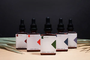 A modern wellness product lineup featuring CBD and cannabis-derived terpene bottles with military-inspired design accents