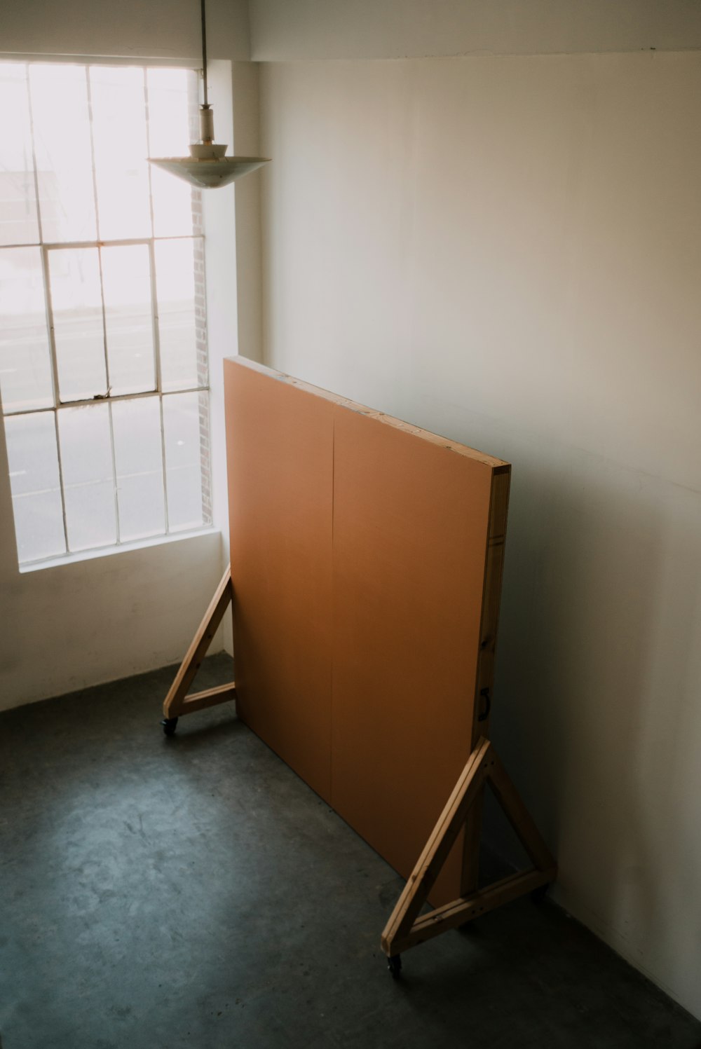 brown wooden cabinet near white wall