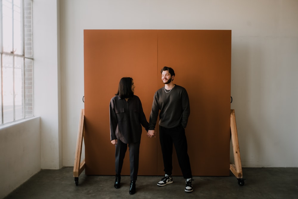 man in black long sleeve shirt standing beside man in black long sleeve shirt