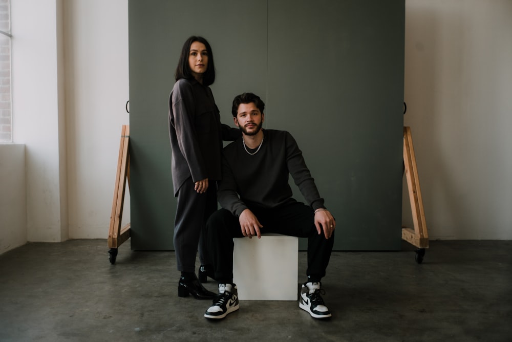 2 women sitting on chair