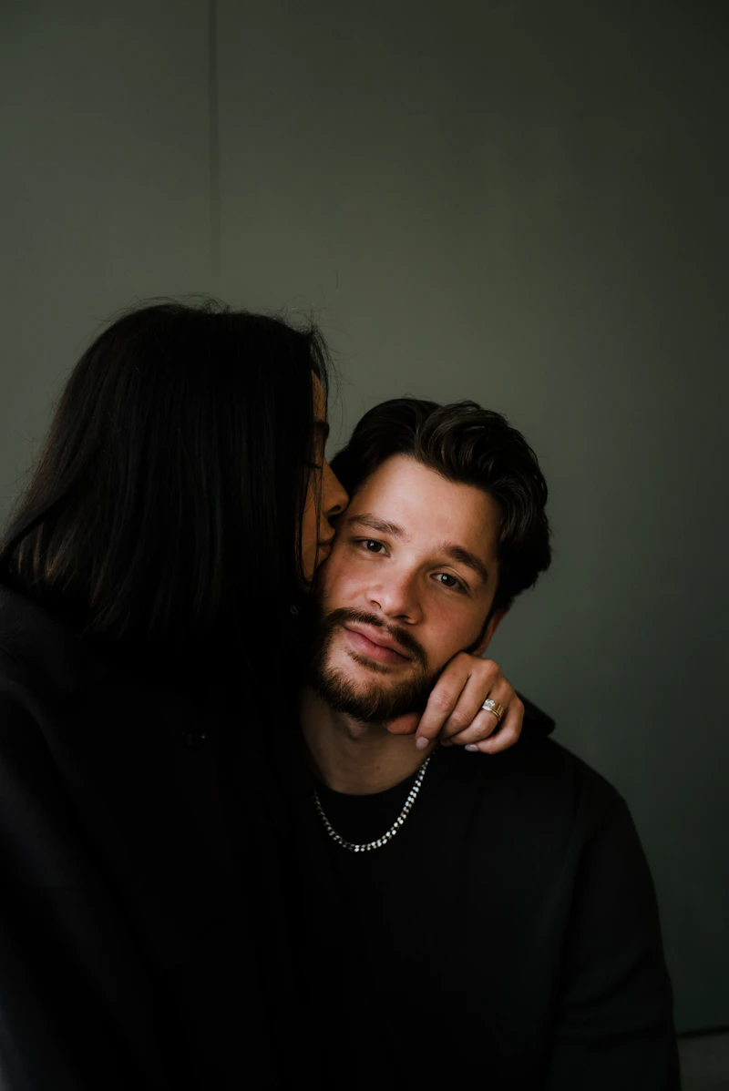 Person framed by a camera viewfinder in low-key dramatic lighting.