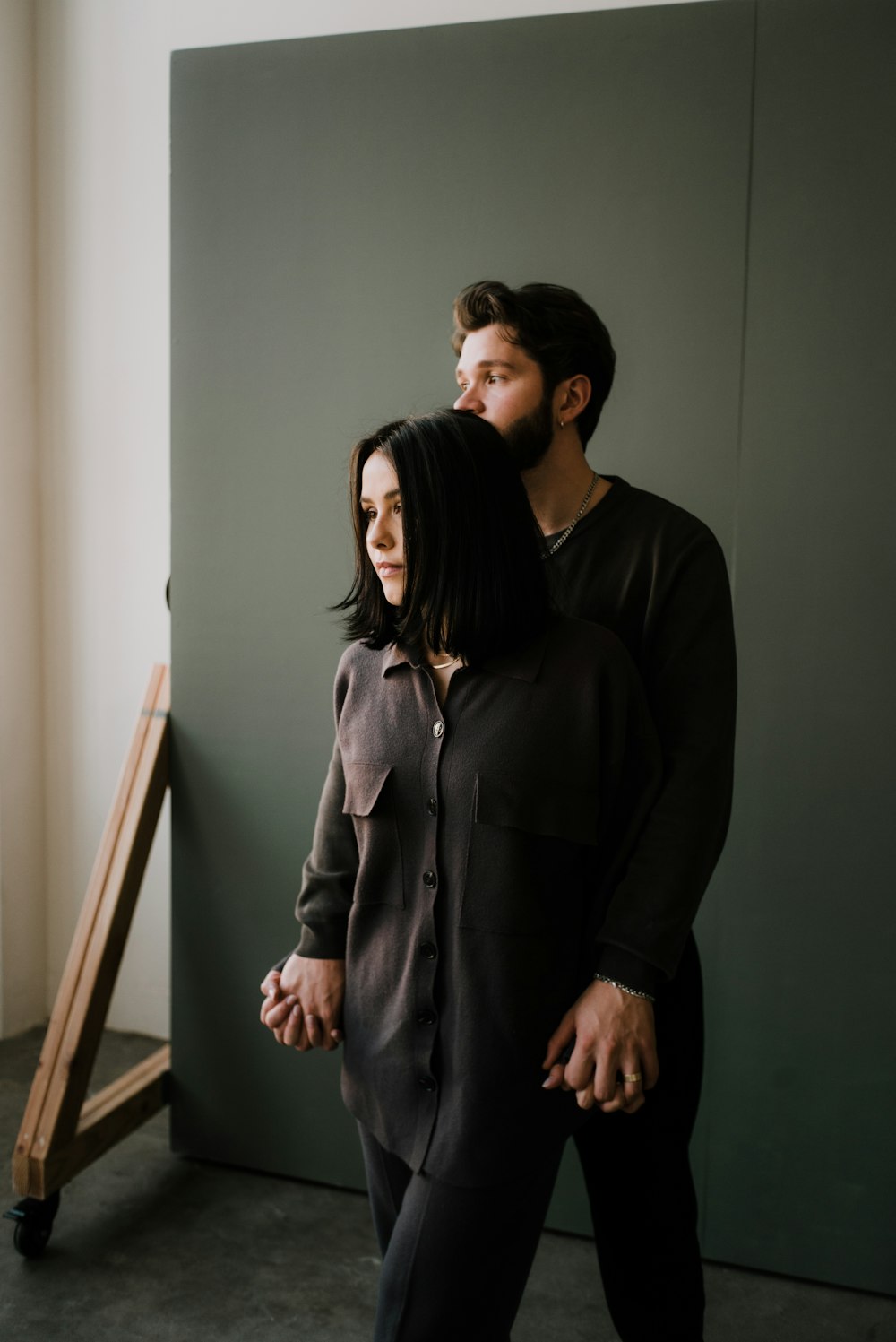 man and woman standing beside wall