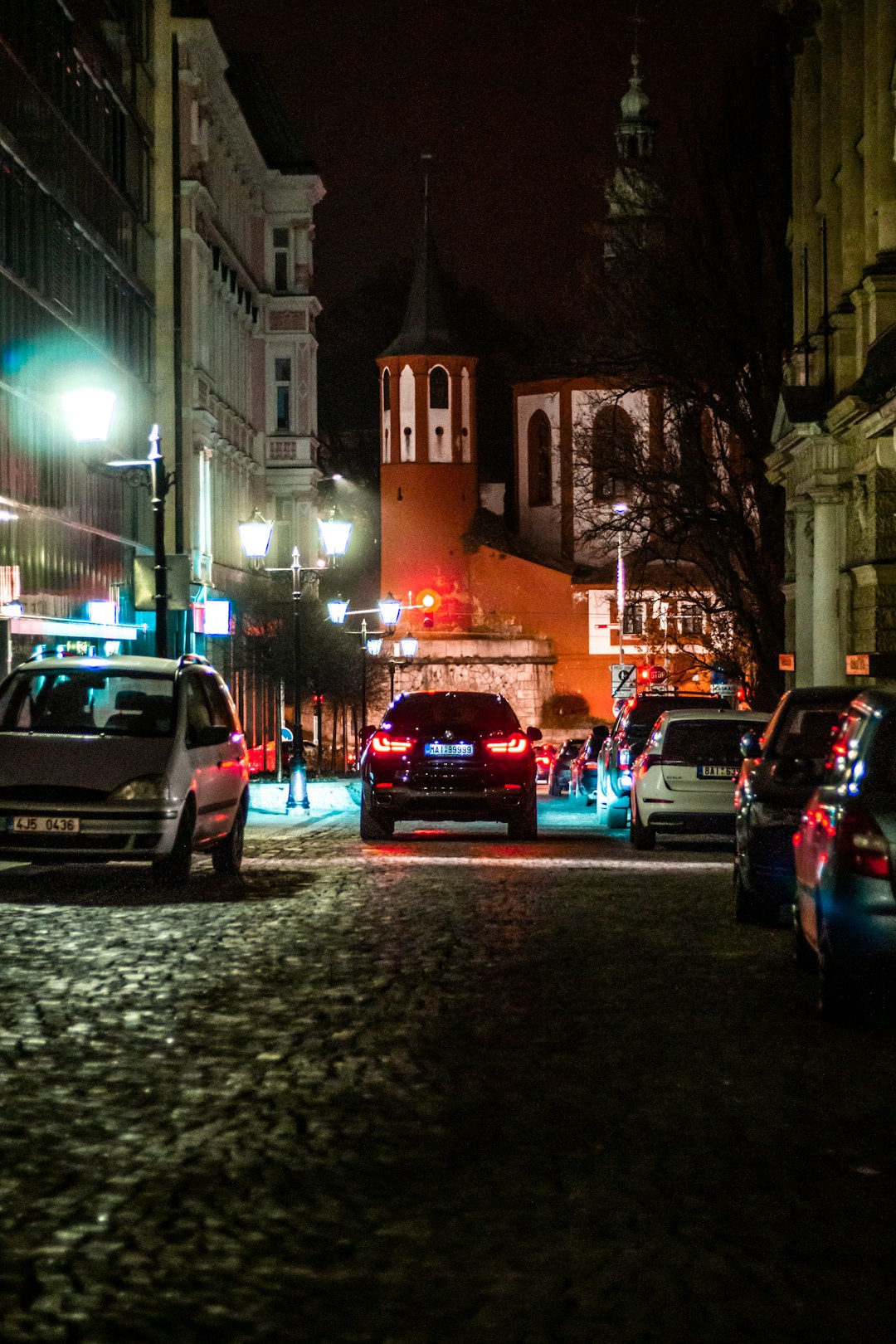 cars parked on the side of the road during night time