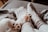 Soft, cozy socks cover human feet resting on a bed or couch, with a cat's paws visible nearby, creating a warm and relaxed setting.