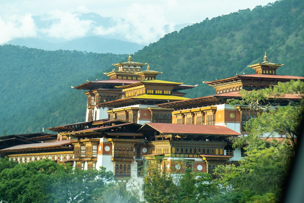 brown and black temple surrounded by green trees during daytime