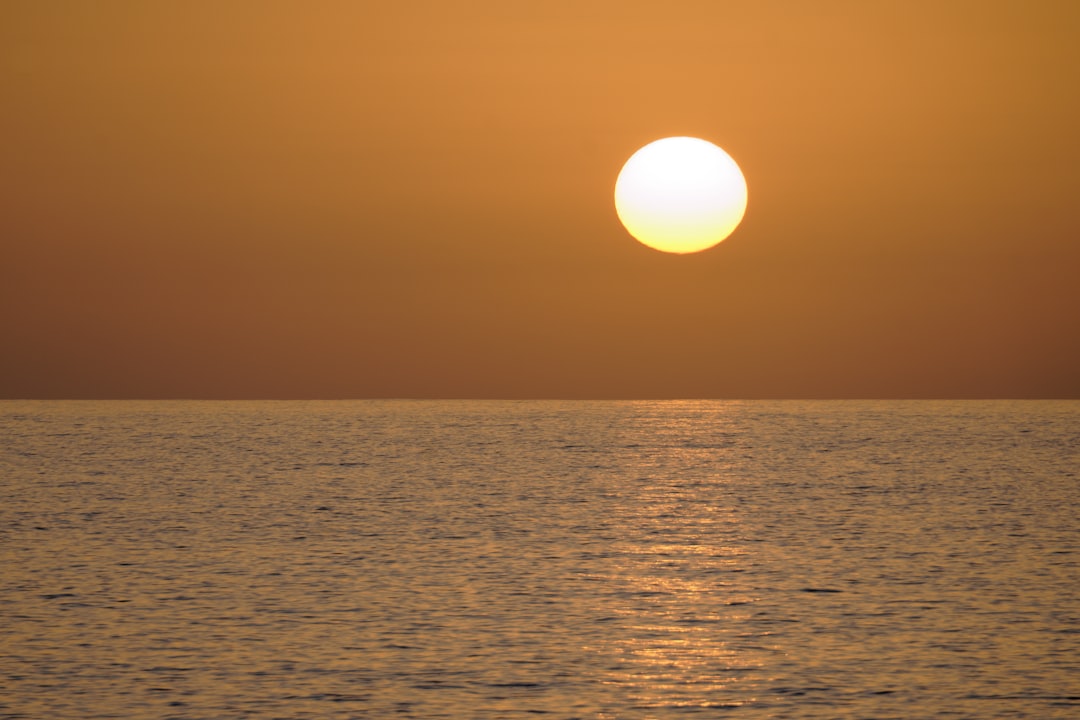 body of water during sunset