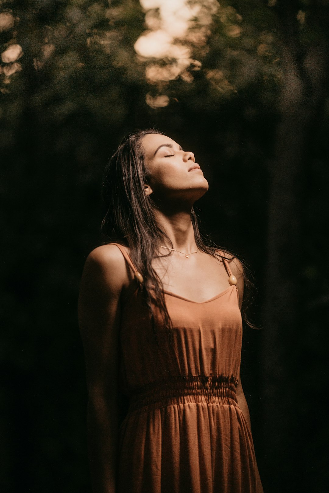 woman in brown spaghetti strap top