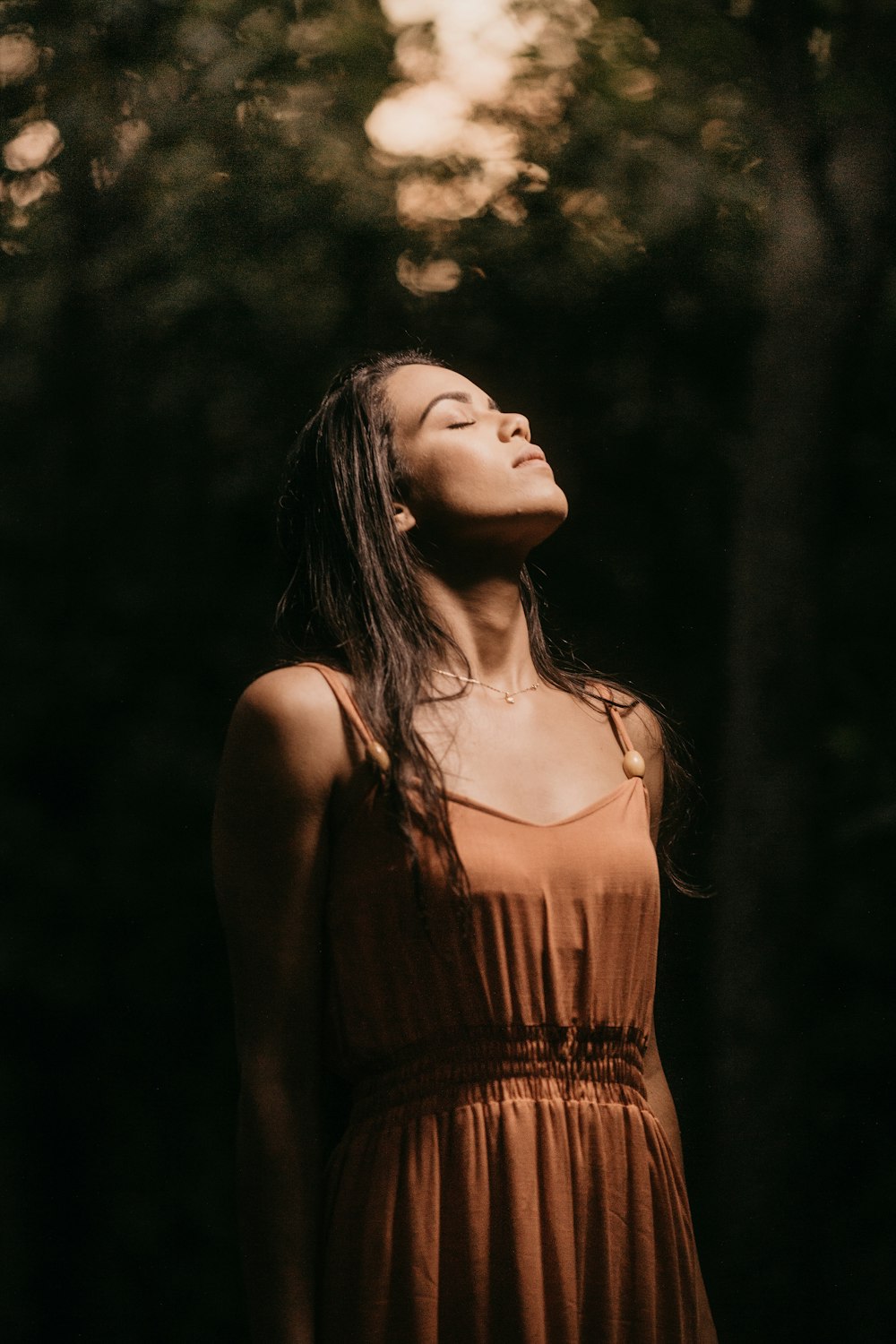 woman in brown spaghetti strap top