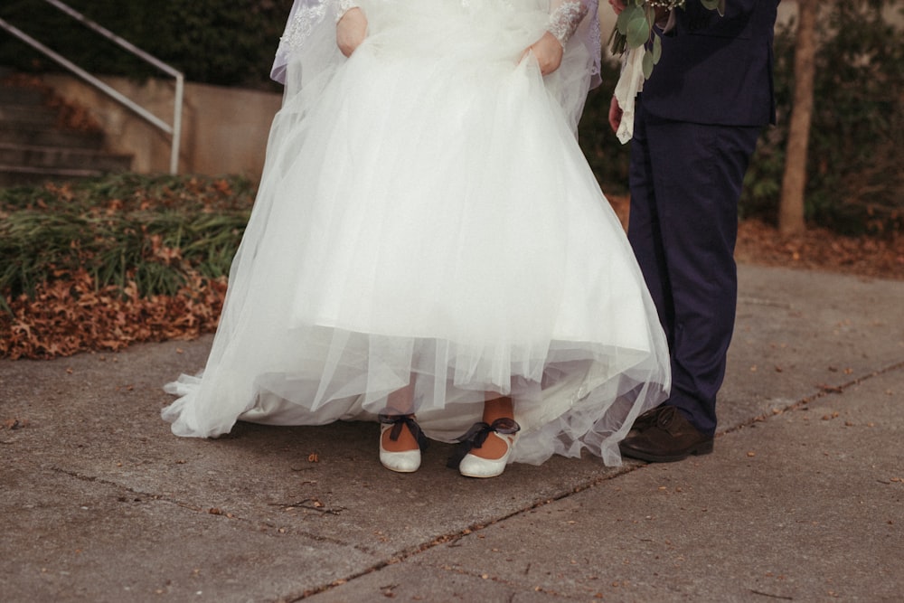 woman in white wedding dress and brown leather shoes
