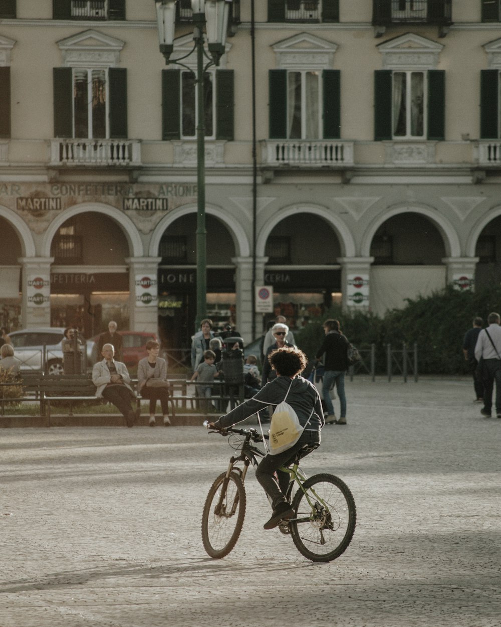 people riding bicycles on road near building during daytime