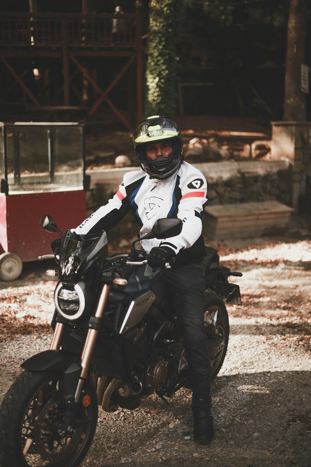 man in white and red motorcycle suit riding motorcycle