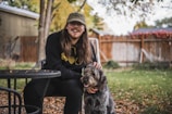 A friendly dog sitter playing with a happy dog in a sunny backyard.