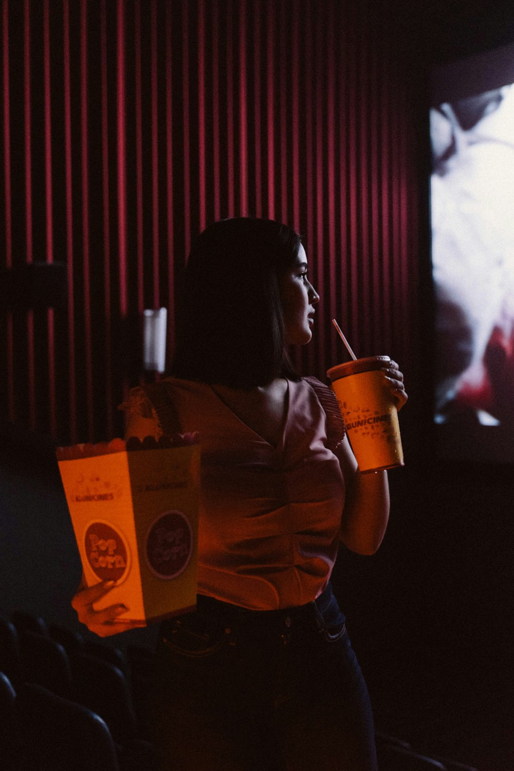 woman in brown leather jacket drinking from brown and white cup