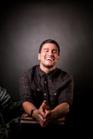 A candid shot of an author laughing during a casual book signing event.